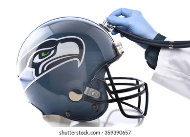 IRVINE, CA - JANUARY 6, 2015: Seattle Seahawks Football Helmet With Stethoscope. Sports Concussion Concept, An Ongoing Problem In The NFL.