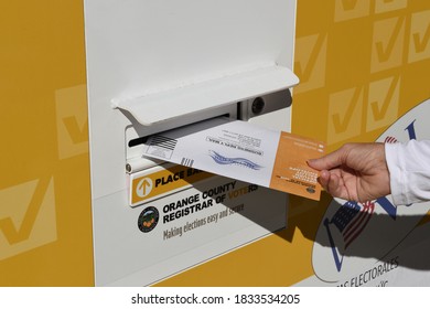 IRVINE, CALIFORNIA - 14 OCT 2020: Woman Placing Mail In Ballot In An Official Ballot Drop Box In In Harvard Park, Irvine, Orange County, California.