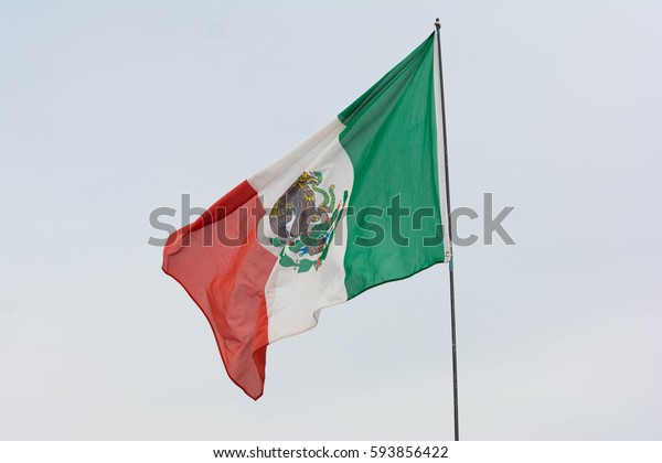 Irwindale, USA - March 4, 2017: Mexican flag\
weaving on sky background on display during 742 Race Wars at the\
Irwindale Speedway.