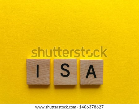 ISA / acronym for Individual Savings Account, in wooden alphabet letters on a plain yellow background with copy space. Creative concept, banking and finance