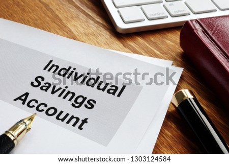 ISA Individual Savings Account. Business papers on an office desk.
