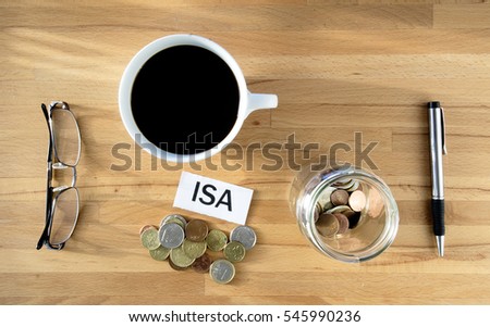 ISA words on desk with coins and pen