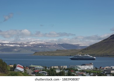 Isafjordur, Iceland - July 28, 2017: Cruise ship docking in village of Isafjordur in Iceland surronded by beautiful landscape of icelandic fjord.