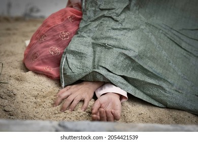 Isalmic woman dead body was cover by sag on sand for, woman dead body was abandon on ground.