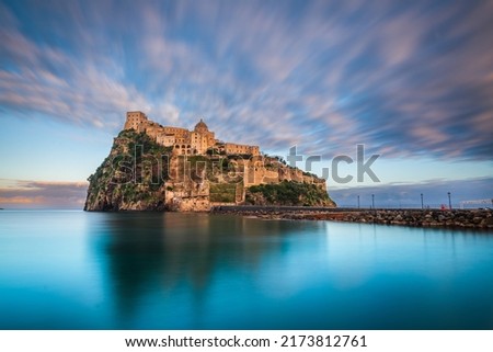Ischia, Italy with Aragonese Castle in the Mediterranean at dusk.