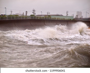 Ise Bay, Japan - September 2018: Storm surge ahead of approaching typhoon creates huge powerful waves which smash into beaches, sea walls, and piers 