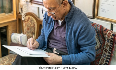 Isfahan, Iran - April 2019: Senior Artist Painting Traditional Iranian Miniature