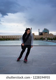 Isfahan, Iran - October, 2018: A Beautiful Young Fashionable Iranian Muslim Women Is Roller Skating In Naqsh-e Jahan Square In The Centre Of Esfahan