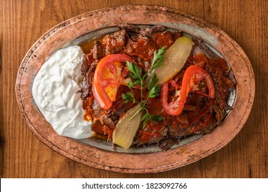 Iskender Kebap / Turkish kebab in a traditional copper plate - Shutterstock ID 1823092766
