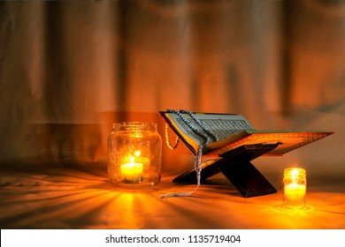 Islam Holy Book Of Muslims, The Quran Is Placed On A Wooden Stand.Light Candles.