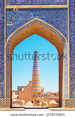 Islam Khoja Minaret. View through the arch. Itchan Kala, inner town of the city of Khiva, Uzbekistan - July 16, 2024.