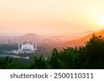 Islamabad, Pakistan - 12th september, 2023: sunset by The Faisal Mosque - fifth-largest mosque in the world. Major tourist attraction in Pakistan. Margalla hills famous sunset viewpoint panorama