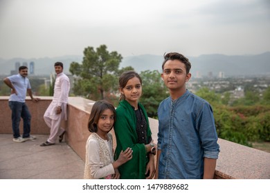 Islamabad, Pakistan - April 9, 2018: A Pakistani Family Of Brother And Two Sisters At Pakistan Monument In Islamabad.