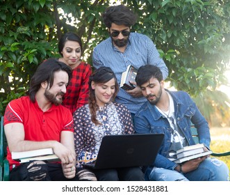 Islamabad, Pakistan. October 8th, 2019. People Enjoying Together In The Park With Laptop In Hand.