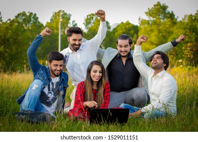 Islamabad.Pakistan 10th October 2019 Education, School And People Concept - Cheerful University Students With Laptop On Group Of Students.