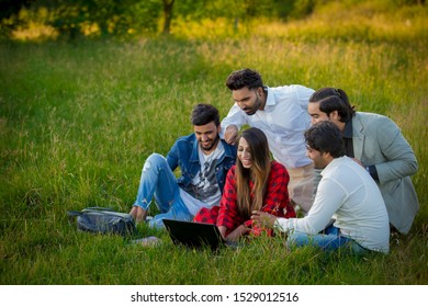 Islamabad.Pakistan 10th October 2019 Education, School And People Concept - Cheerful University Students With Laptop On Group Of Students.