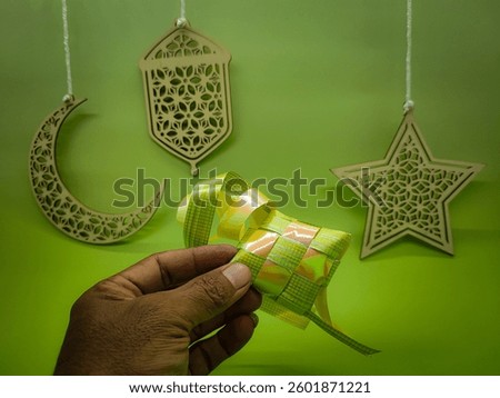 Islamic background decoration for Ramadan and Eid. There are hand holding 