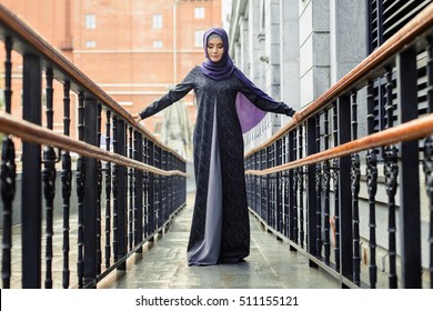 Islamic Beautiful Woman In A Muslim Dress Standing On A European Street