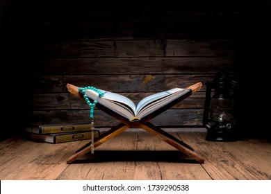 Islamic concept - The Holy Al Quran with written Arabic calligraphy meaning of Al Quran and rosary beads or tasbih, Arabic word translation : The Holy Al Quran (holy book of Muslim) - Shutterstock ID 1739290538