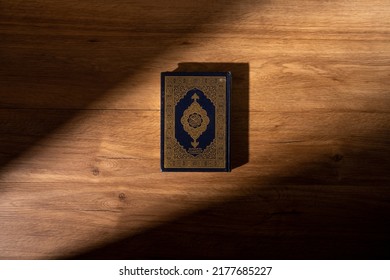 Islamic concept - The Holy Al Quran with written Arabic calligraphy meaning of Al Quran, Arabic word translation : The Holy Al Quran (holy book of Muslim), on black background, with copy space. - Shutterstock ID 2177685227