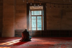 Islamic Concept Photo. Muslim Man Praying In The Mosque And Sunlight Rays With Haze In The Morning. Ramadan Or Kandil Or Laylat Al-qadr Or Kadir Gecesi Background Photo.