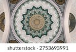 Islamic decorations. Islamic geometric pattern on mosque dome ceiling with ornate green and gold decoration