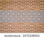 Islamic geometrical pattern tiles, blue golden yellow and orange in the Alcazaba fortress, Malaga, Andalusia, Spain