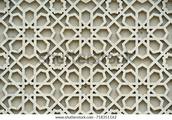 Islamic geometry\
pattern made from ground fibre reinforcement concrete used as\
building facade wall decoration.\
