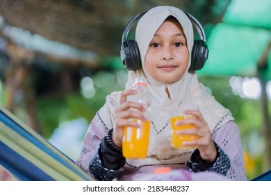 Islamic Girl Drinking Orange Juice
