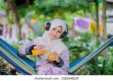 Islamic Girl Drinking Orange Juice
