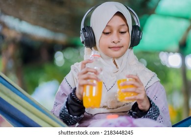 Islamic Girl Drinking Orange Juice
