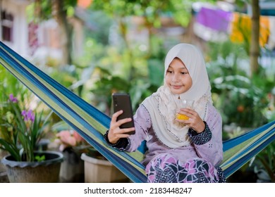 Islamic Girl Drinking Orange Juice
