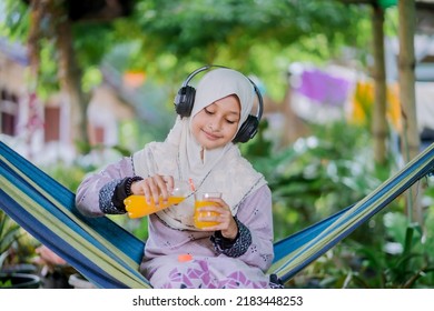 Islamic Girl Drinking Orange Juice
