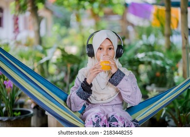 Islamic Girl Drinking Orange Juice
