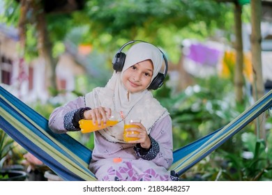 Islamic Girl Drinking Orange Juice
