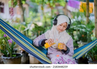 Islamic Girl Drinking Orange Juice
