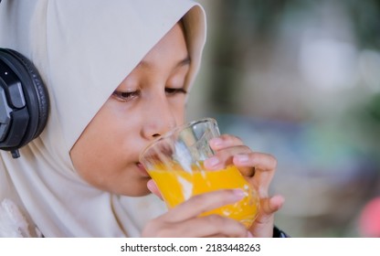 Islamic Girl Drinking Orange Juice
