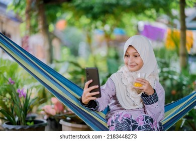 Islamic Girl Drinking Orange Juice
