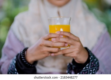 Islamic Girl Drinking Orange Juice
