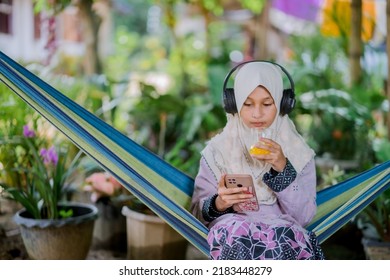 Islamic Girl Drinking Orange Juice
