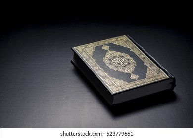 Islamic Holy Book Quran Under Soft Light On Black Background