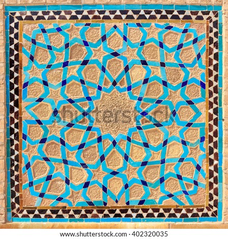 Islamic pattern of a mosaic in Iranian style outside Yazd Mosque, Iran. Tiled oriental ornaments from Iran are found in mosques and important buildings