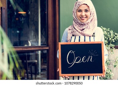 Islamic Woman Small Business Owner Holding Blackboard With Smiling