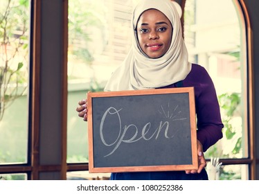 Islamic Woman Small Business Owner Holding Blackboard With Smiling