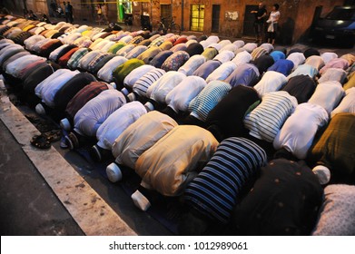 islamic young people during the prayer in a little mosque of rome