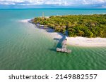 Island. Florida beach. Panorama of Sanibel island in Lee County FL. Spring or Summer vacations in USA. Blue-turquoise color of salt water. Ocean or Gulf of Mexico. Tropical Nature. Aerial view.