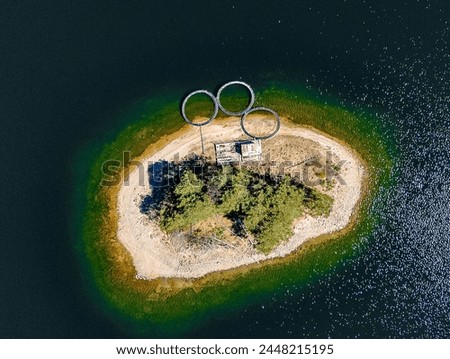Island inside the Dospat dam with fishing circles