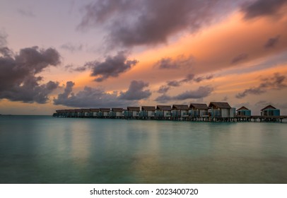 Island In Ocean, Overwater Villas At The Time Sunset. Crossroads Maldives, Hard Rock Hotel. July 2021. Long Exposure Picture