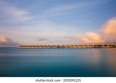 Island In Ocean, Overwater Villas At The Time Sunset With Rainbow. Crossroads Maldives, Saii Lagoon Hotel. July 2021. Long Exposure Picture