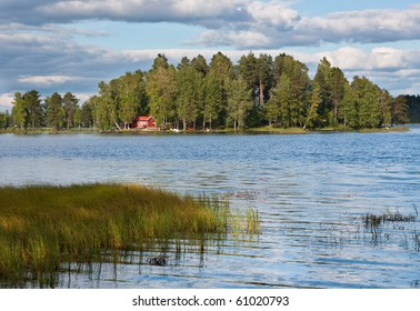 Island On Lake In Finland With Red Summer Cottage